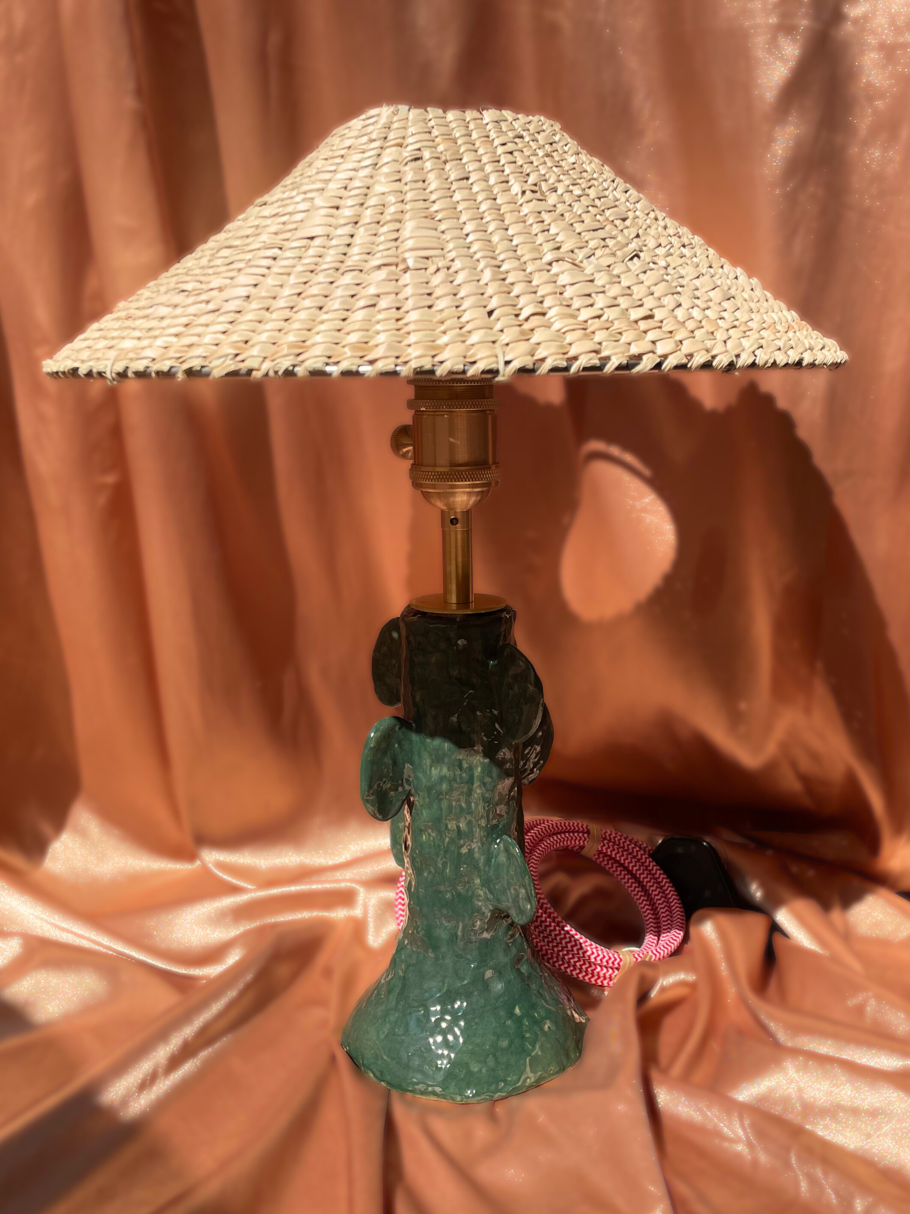 Lamp with a textured shade on a brown fabric background