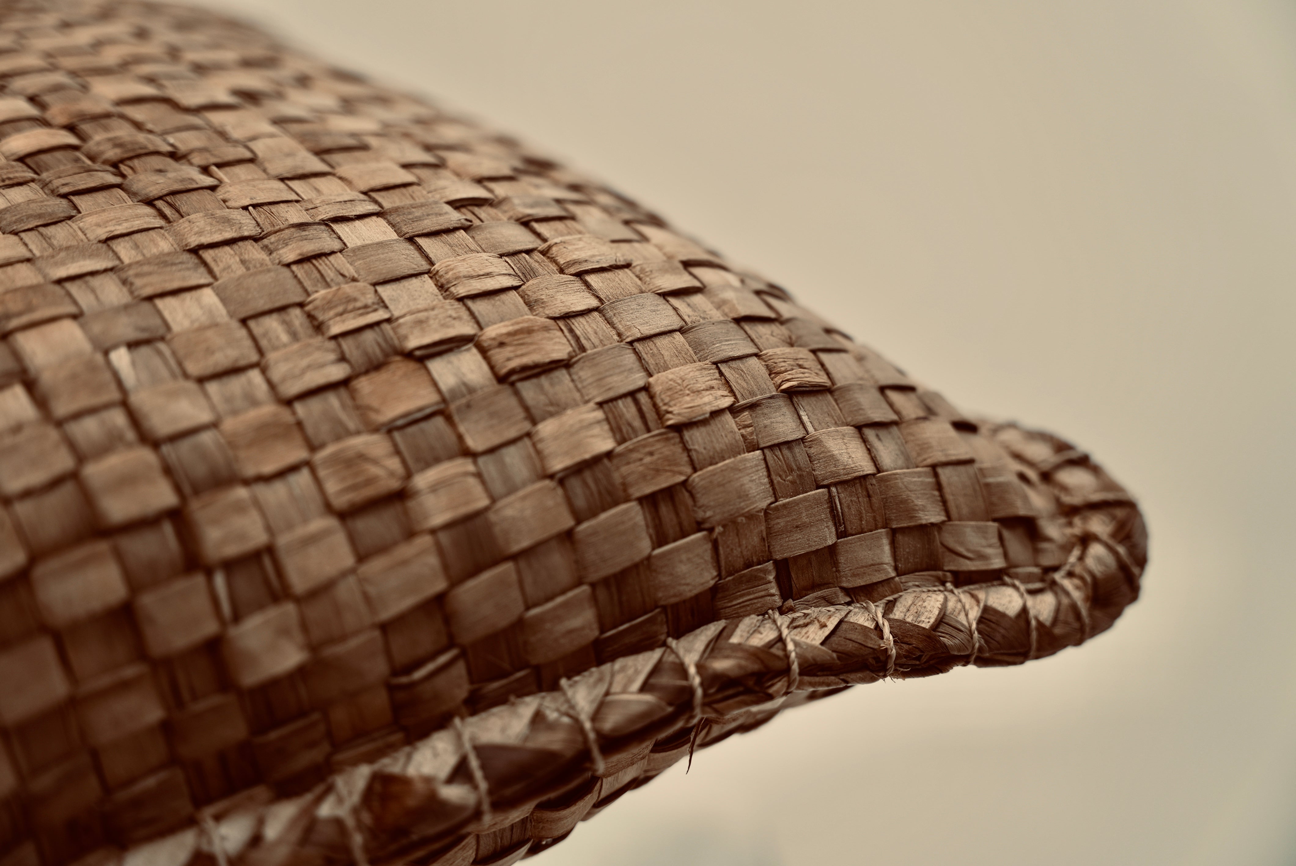 The crispy woven cushion photographed up close to showcase the intricate weaving pattern