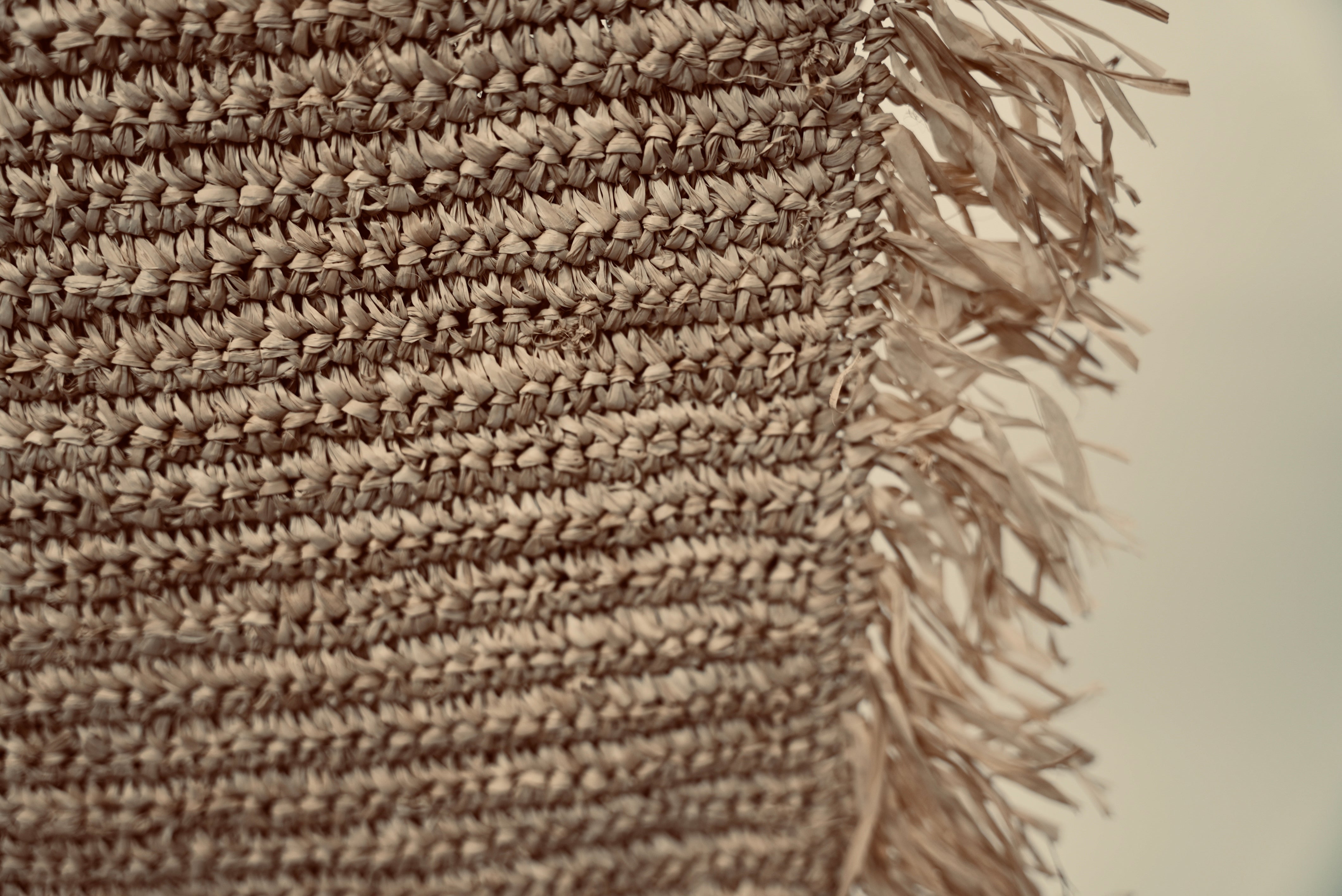 A close-up of the Raffia cushion cover to showcase the weaving
