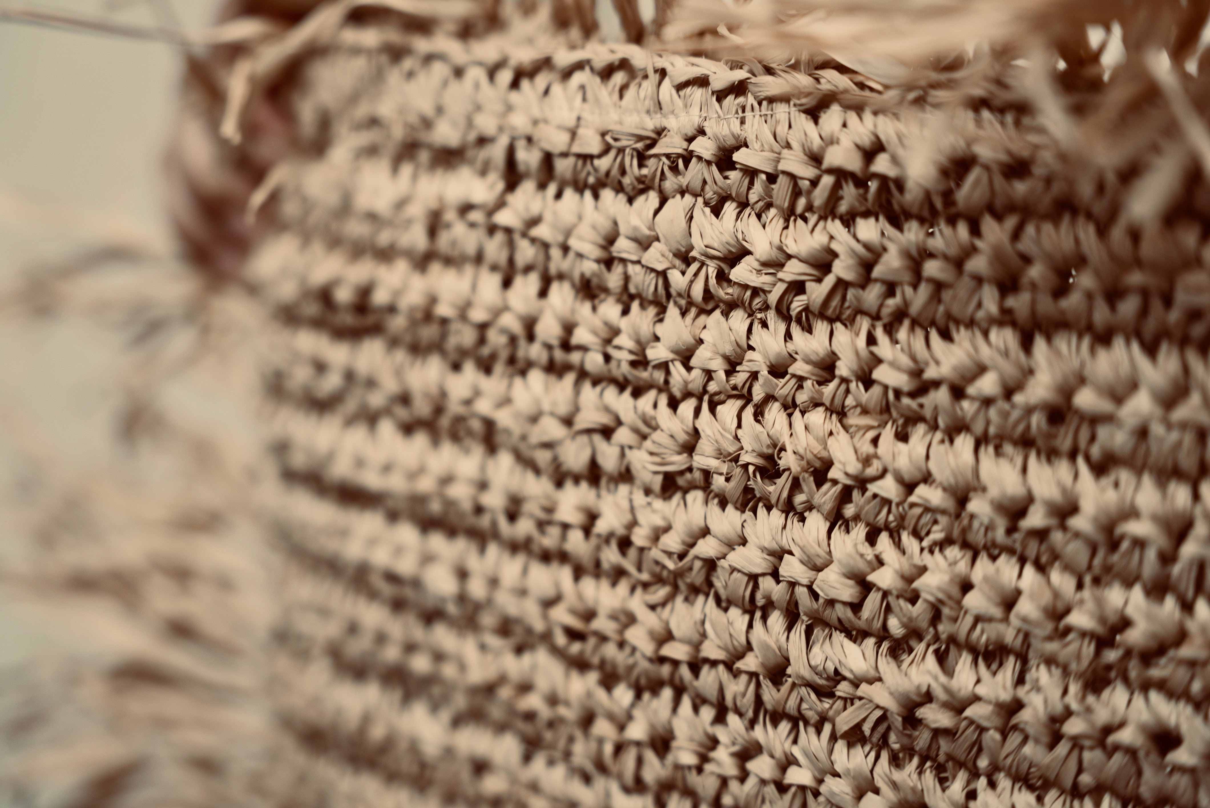 A close-up of the Raffia cushion cover to showcase the intricate handweaved pattern