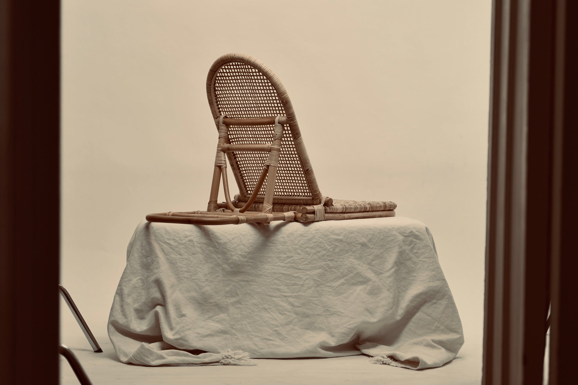 The foldup Rattan beach chair photographed from behind against a neutral background