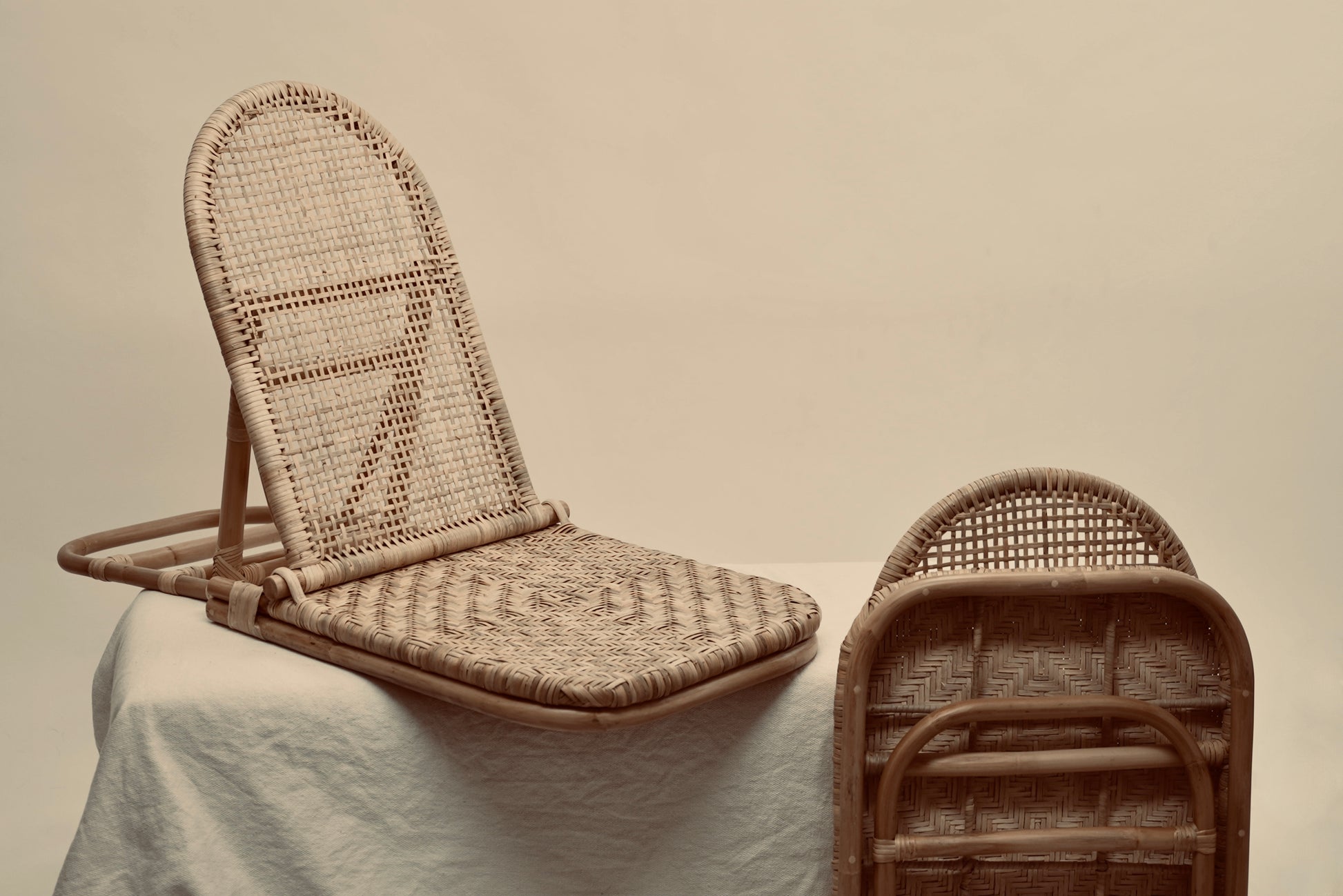 The foldup Rattan beach chair photographed against a neutral background
