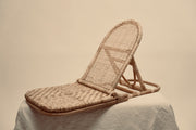 The foldup Rattan beach chair photographed against a neutral background