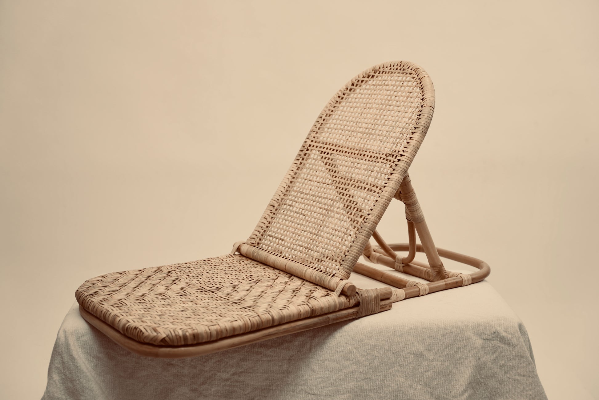 The foldup Rattan beach chair photographed against a neutral background