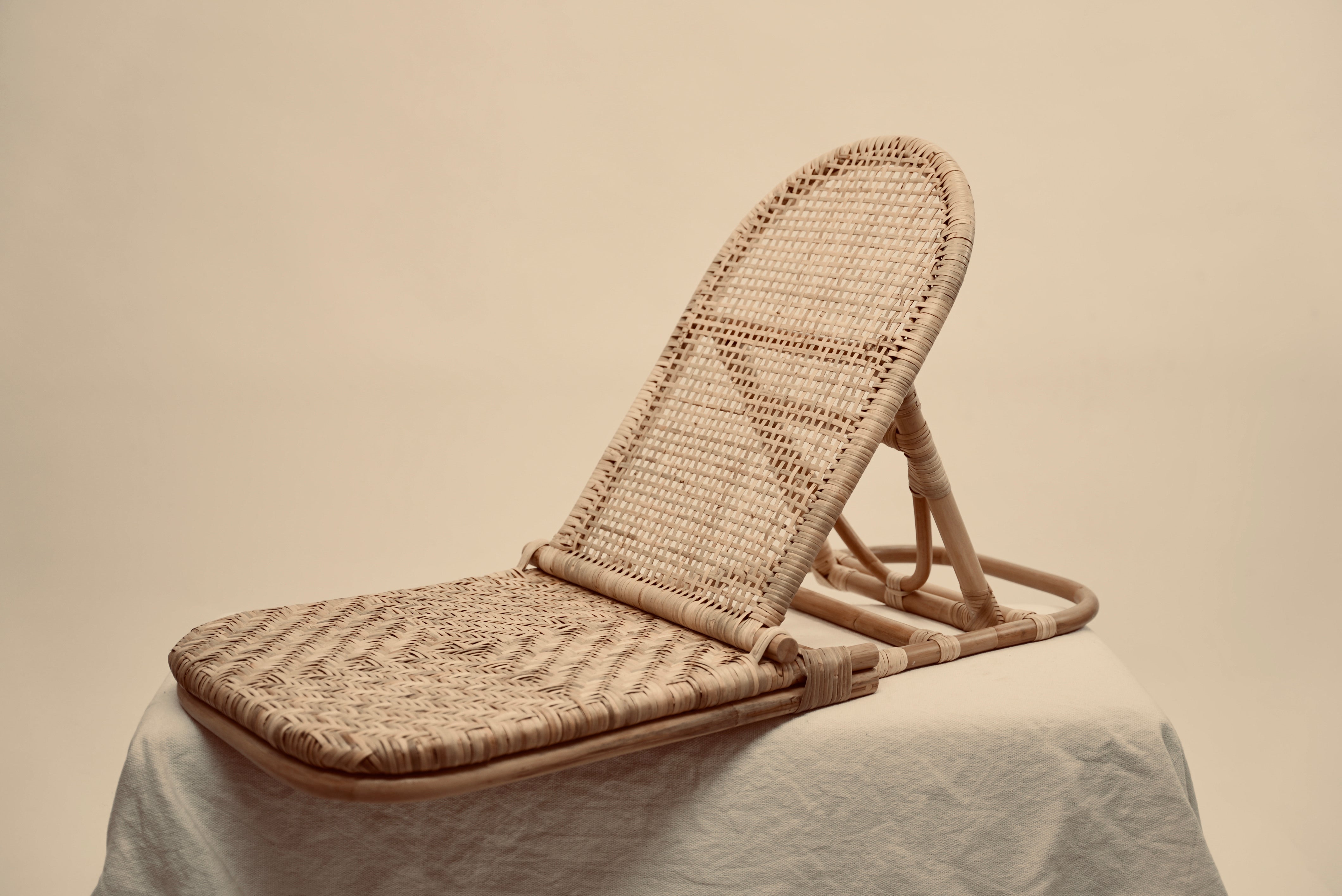 The foldup Rattan beach chair photographed against a neutral background
