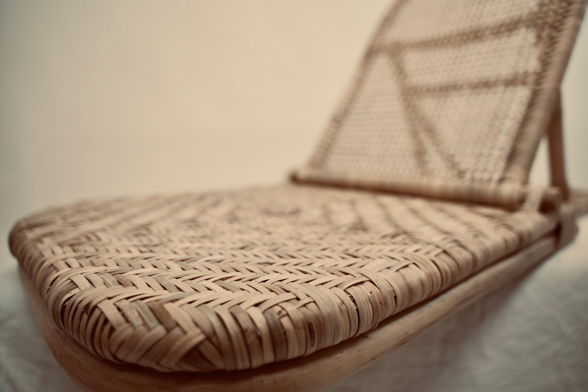 A close-up of the foldup Rattan beach chair photographed against a neutral background