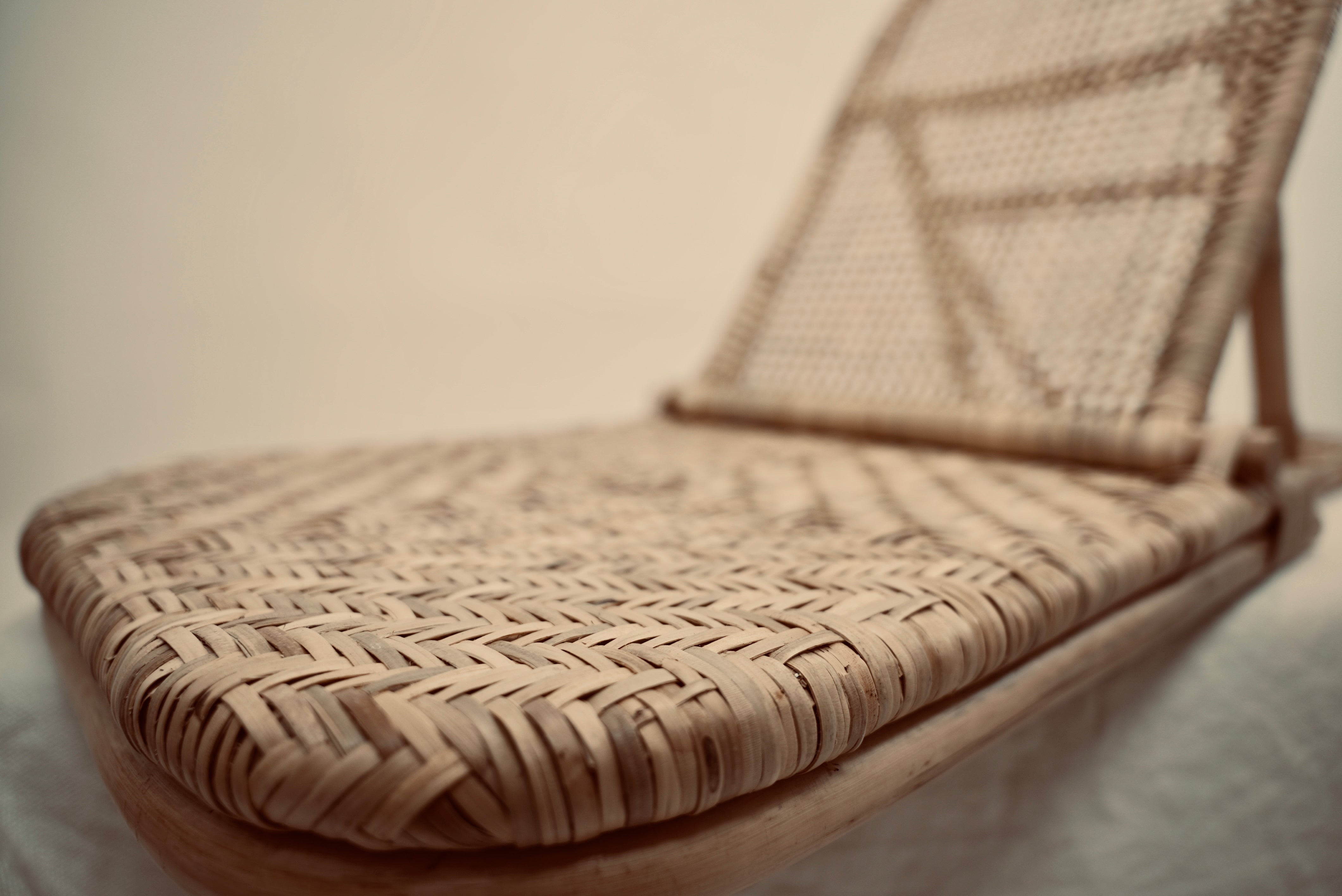 A close-up of the foldup Rattan beach chair photographed against a neutral background