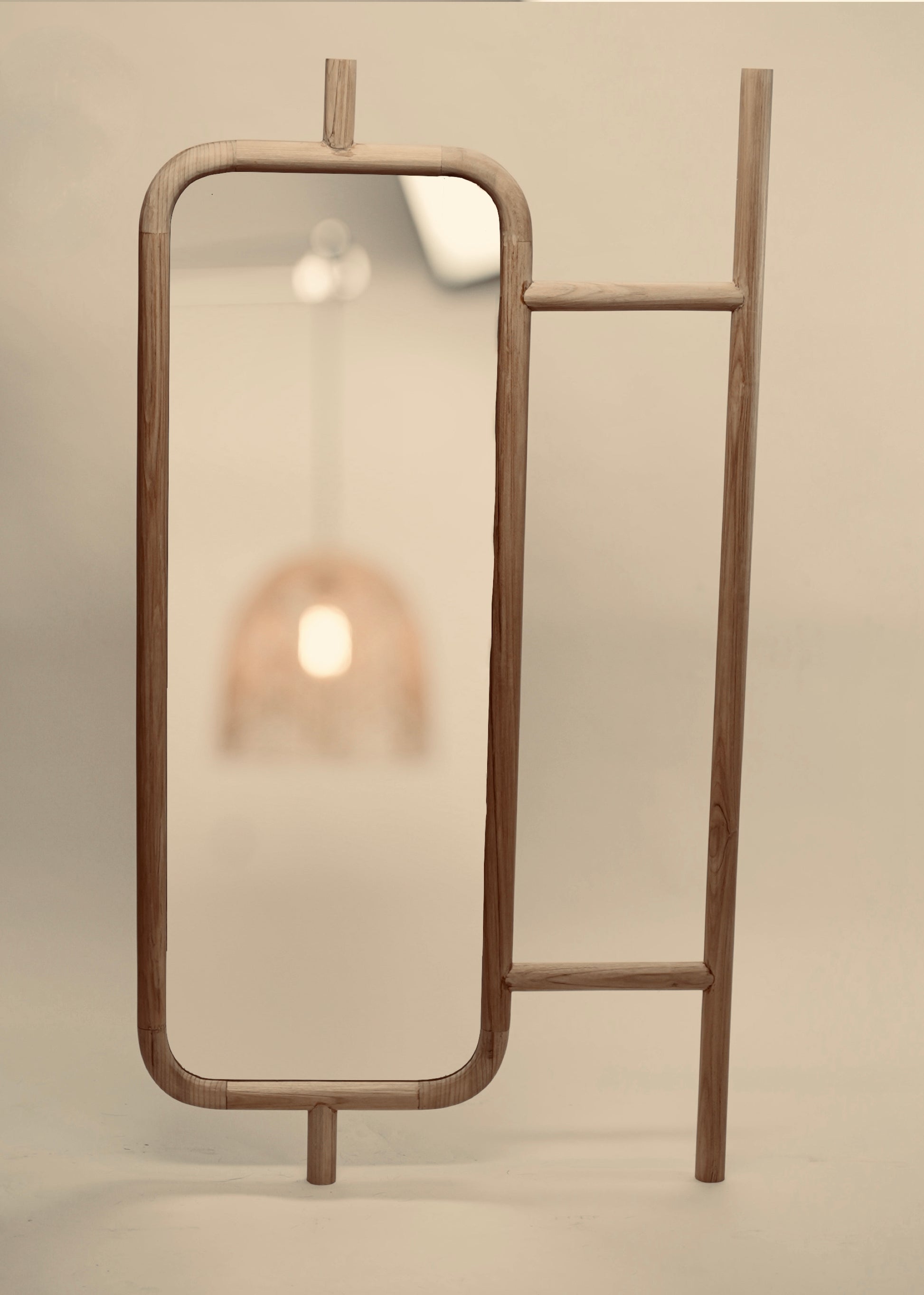 A close-up of the Muji mirror photographed against a neutral background
