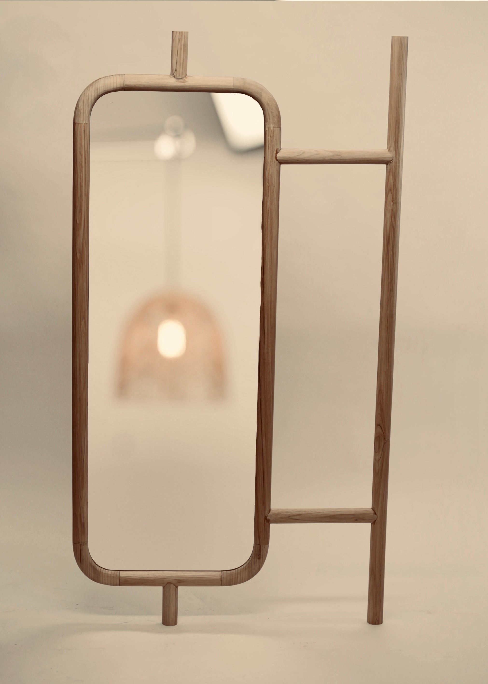 A close-up of the Muji mirror photographed against a neutral background