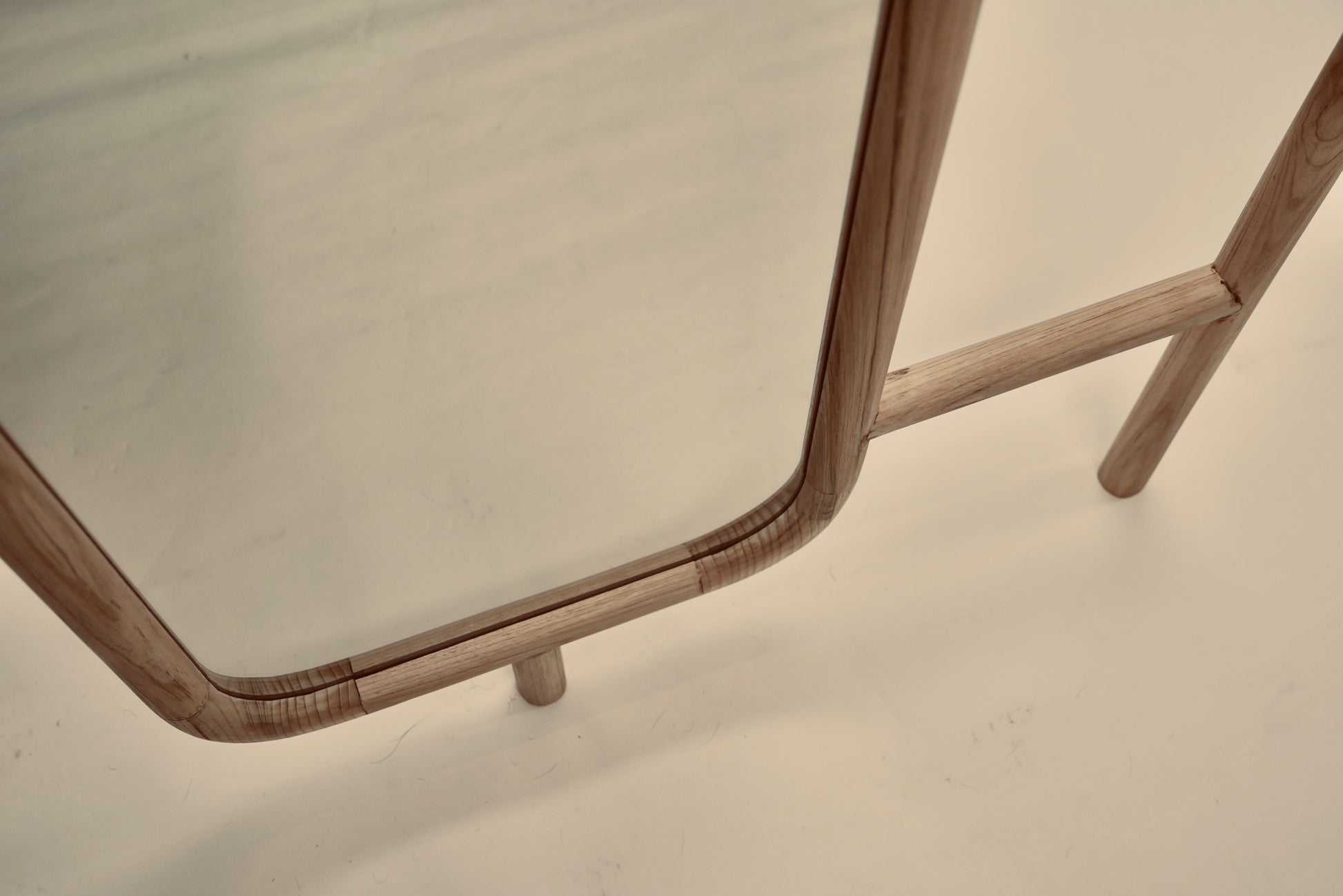 A close-up of the Muji mirror photographed against a neutral background