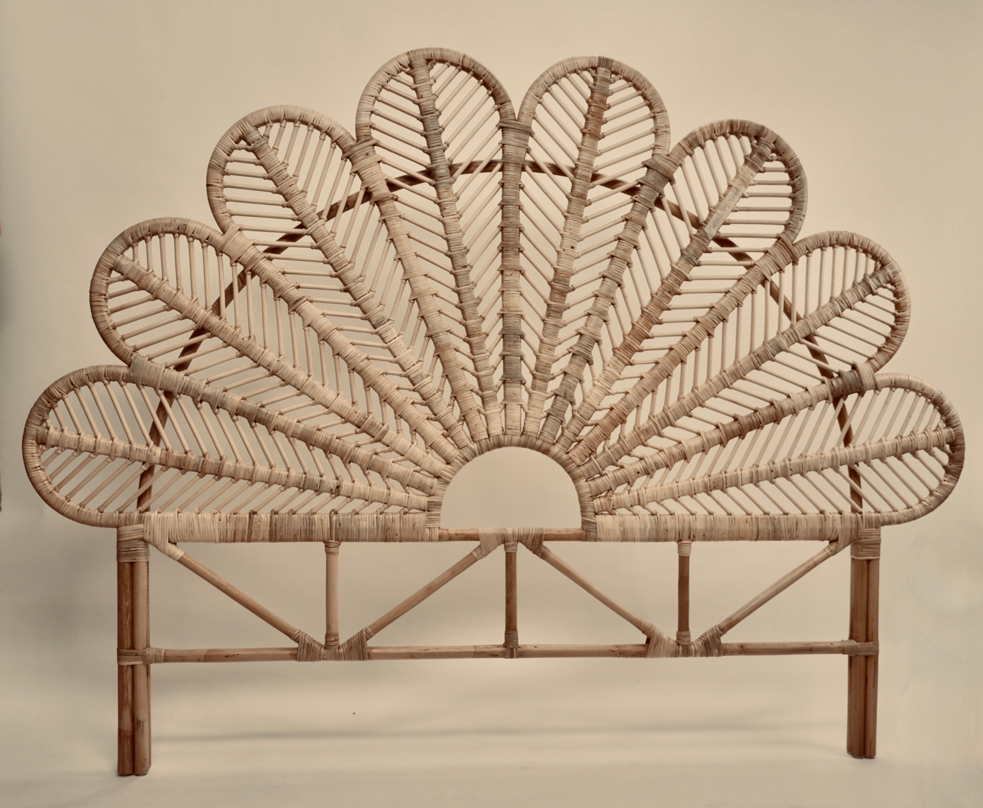The Rattan Ibu headboard photographed against a neutral headboard