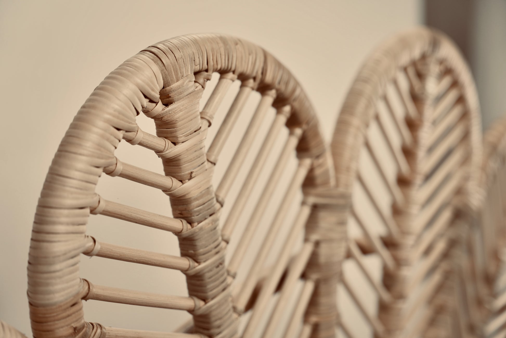 A close-up of the Rattan Ibu headboard photographed against a neutral headboard