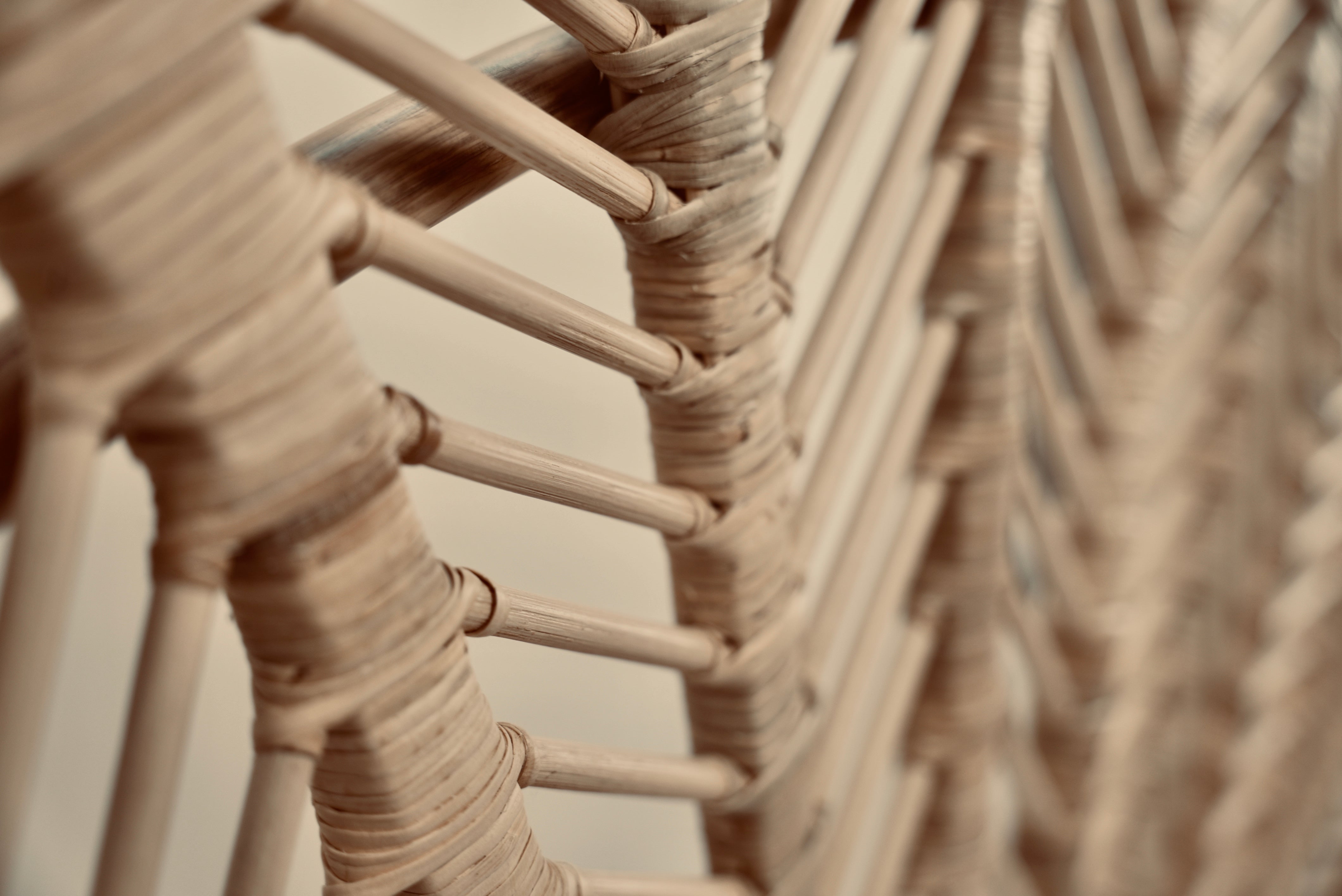A close-up of the Rattan Ibu headboard photographed against a neutral headboard
