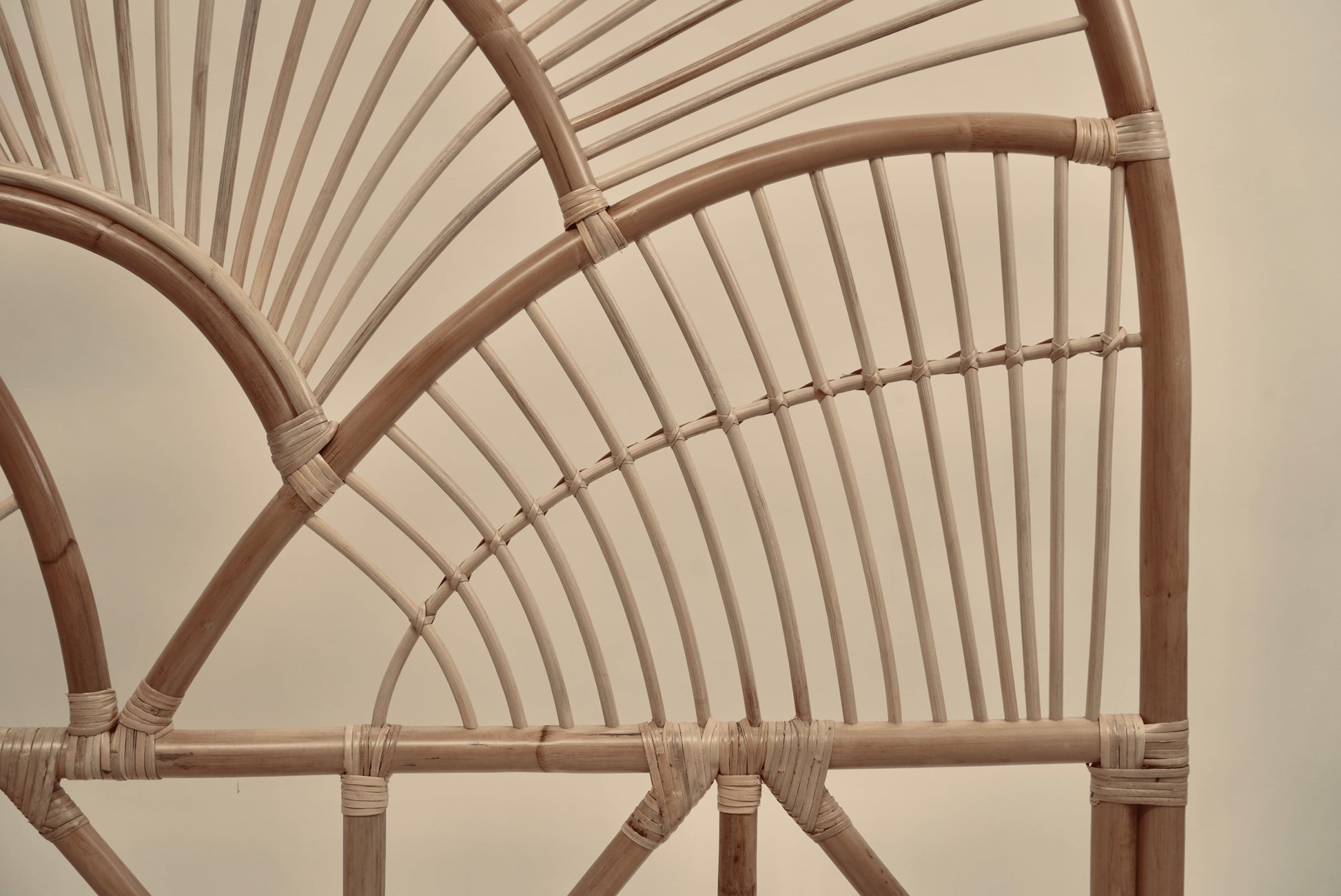 The Muji headboard photographed against a neutral wall showcasing the intricate curved details