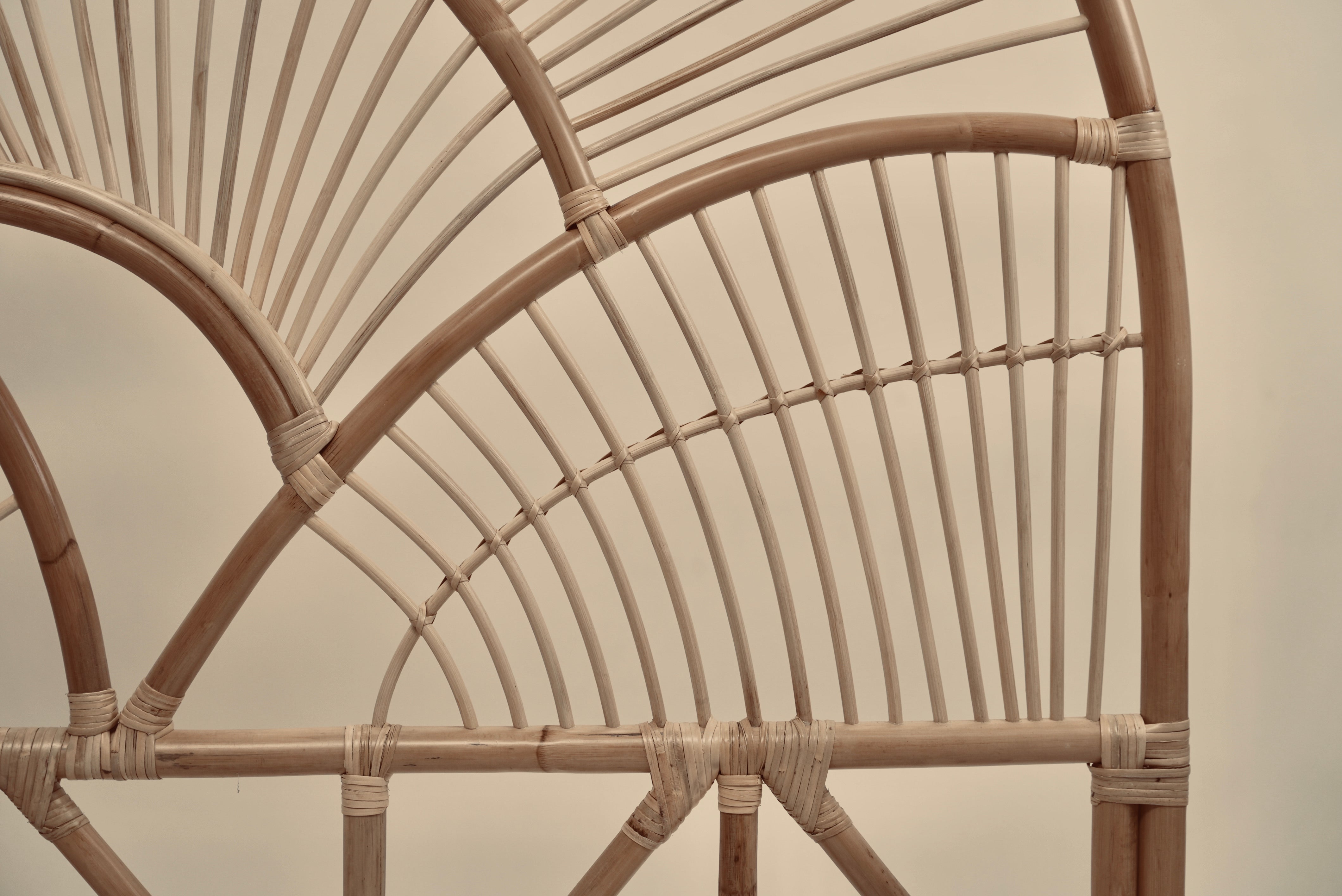 The Muji headboard photographed against a neutral wall showcasing the intricate curved details
