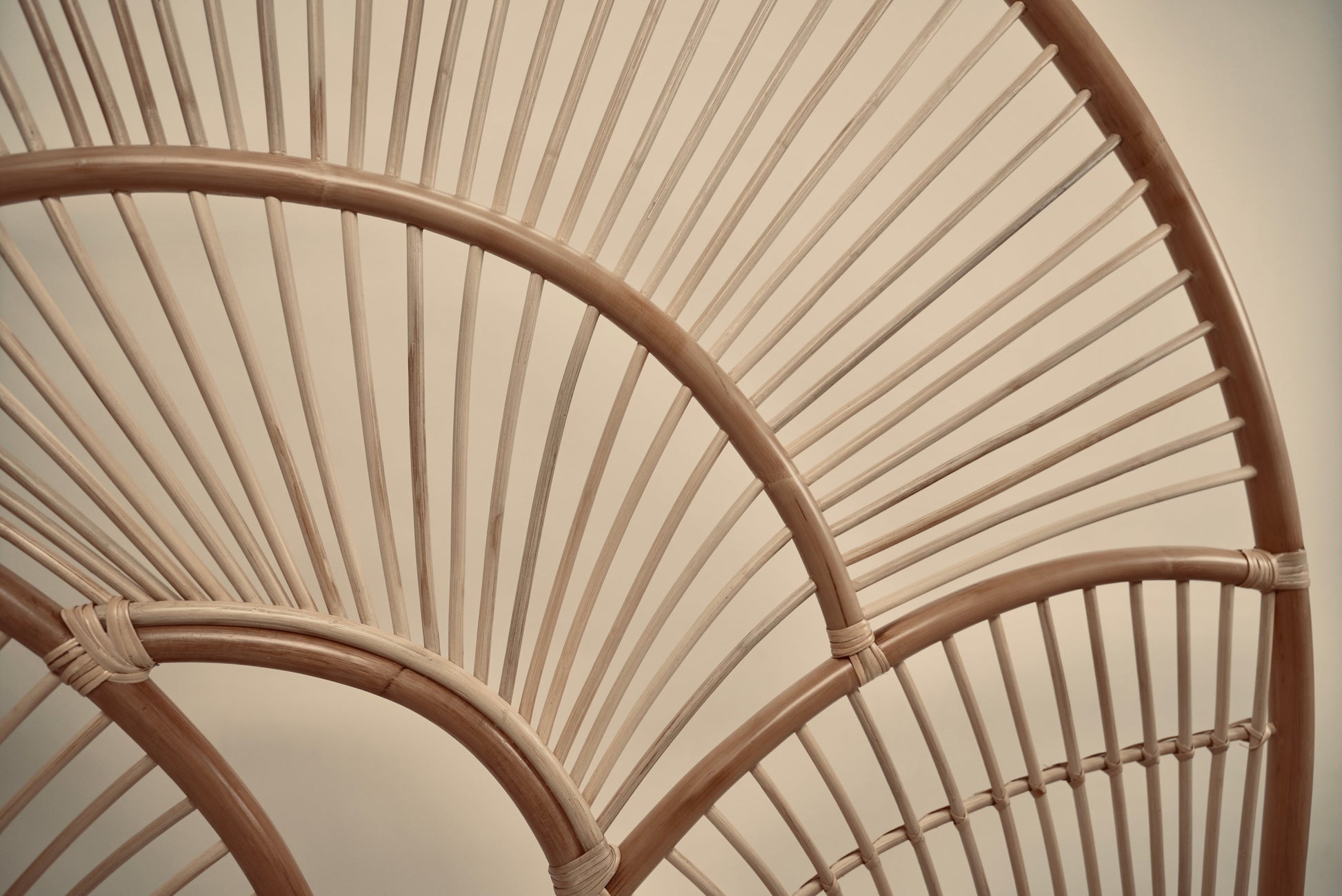 The Muji headboard photographed against a neutral wall showcasing the intricate curved details
