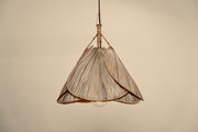 The palm leaf lampshade photographed against a neutral background