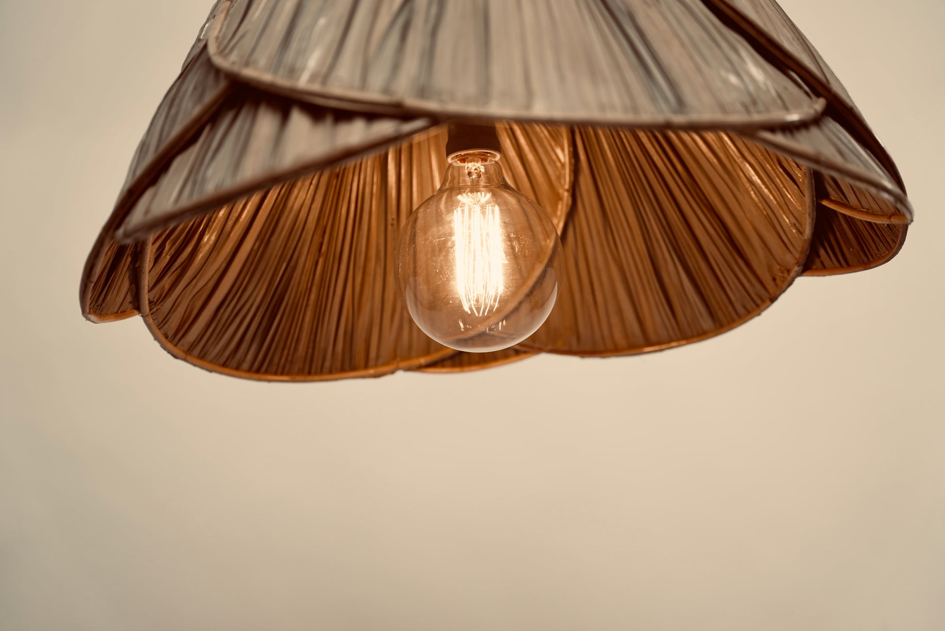 A close-up of the palm leaf lampshade photographed against a neutral background