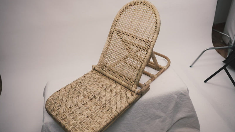 The foldup Rattan beach chair photographed against a neutral background