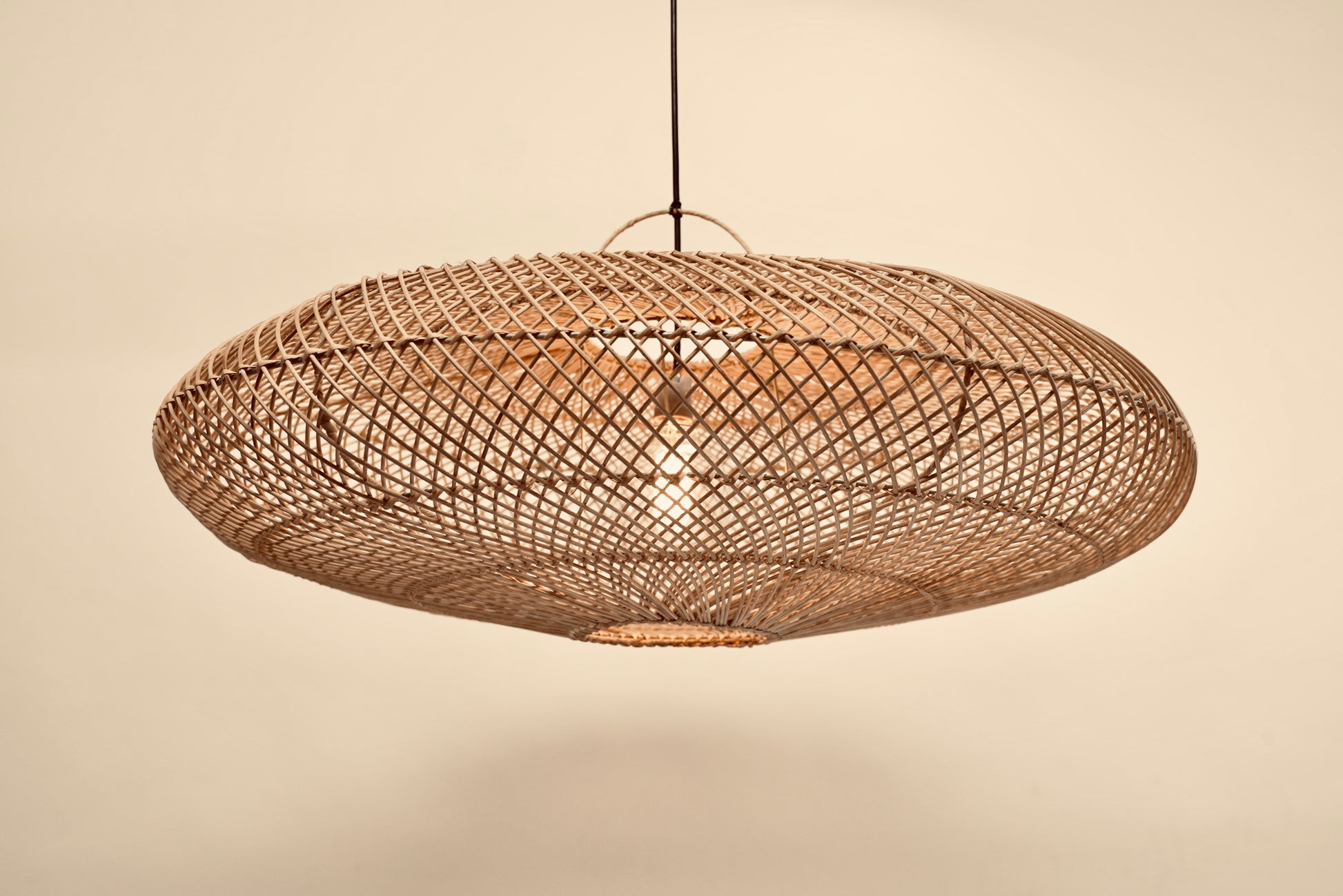 The UFO pendant hanging against a neutral background