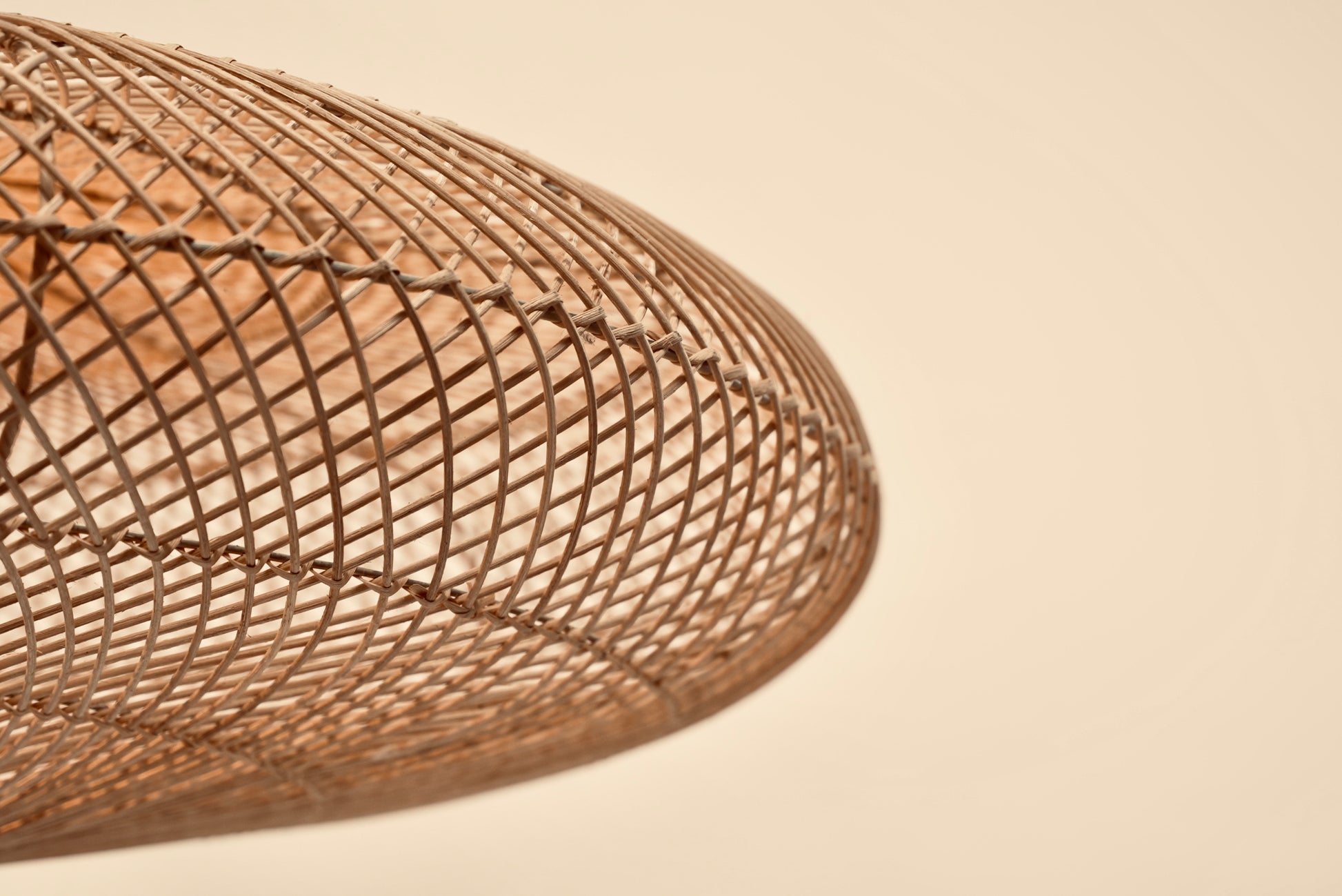 A close-up of the UFO pendant hanging against a neutral background showcasing the designs