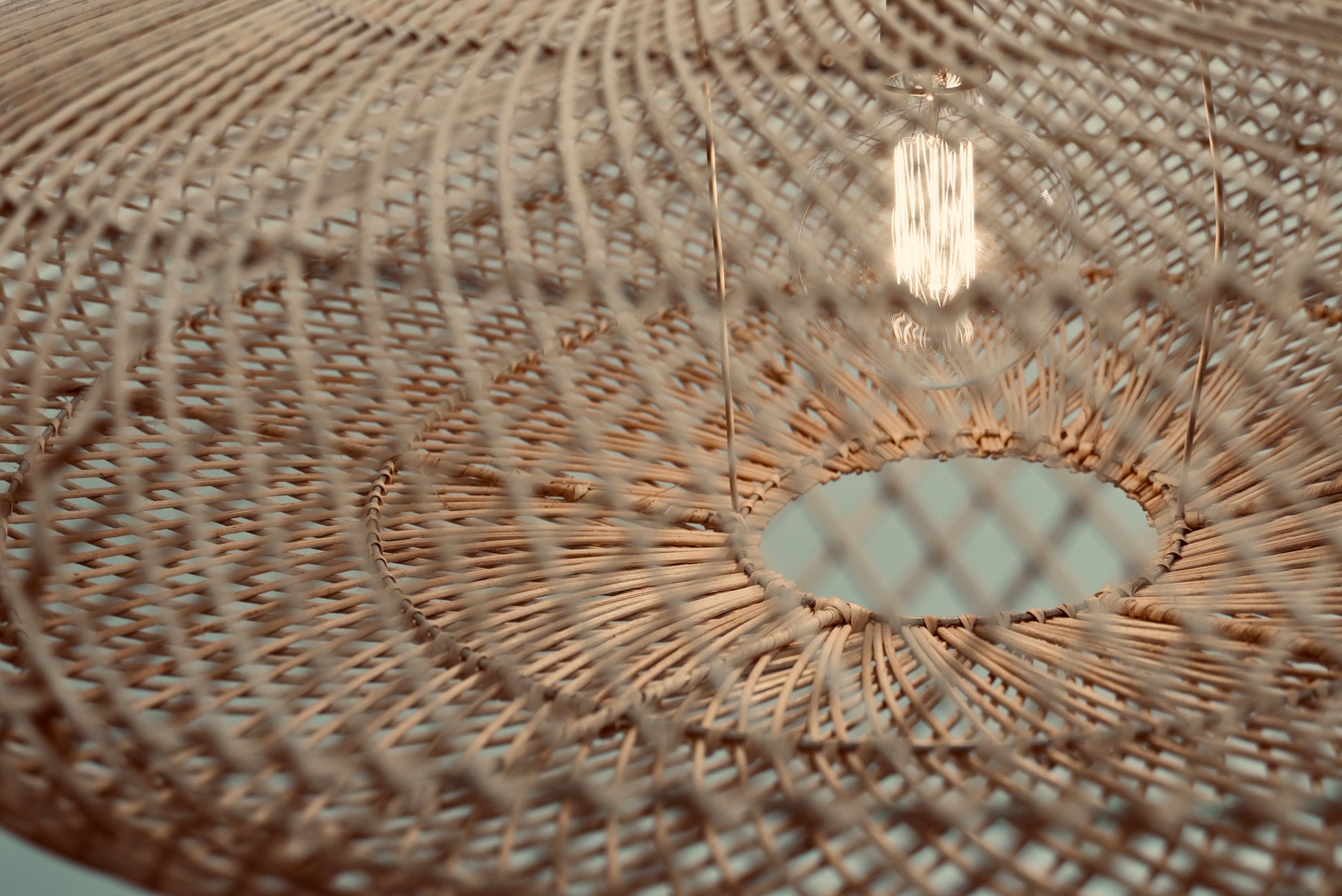 Close-up of the UFO pendant hanging against a neutral background