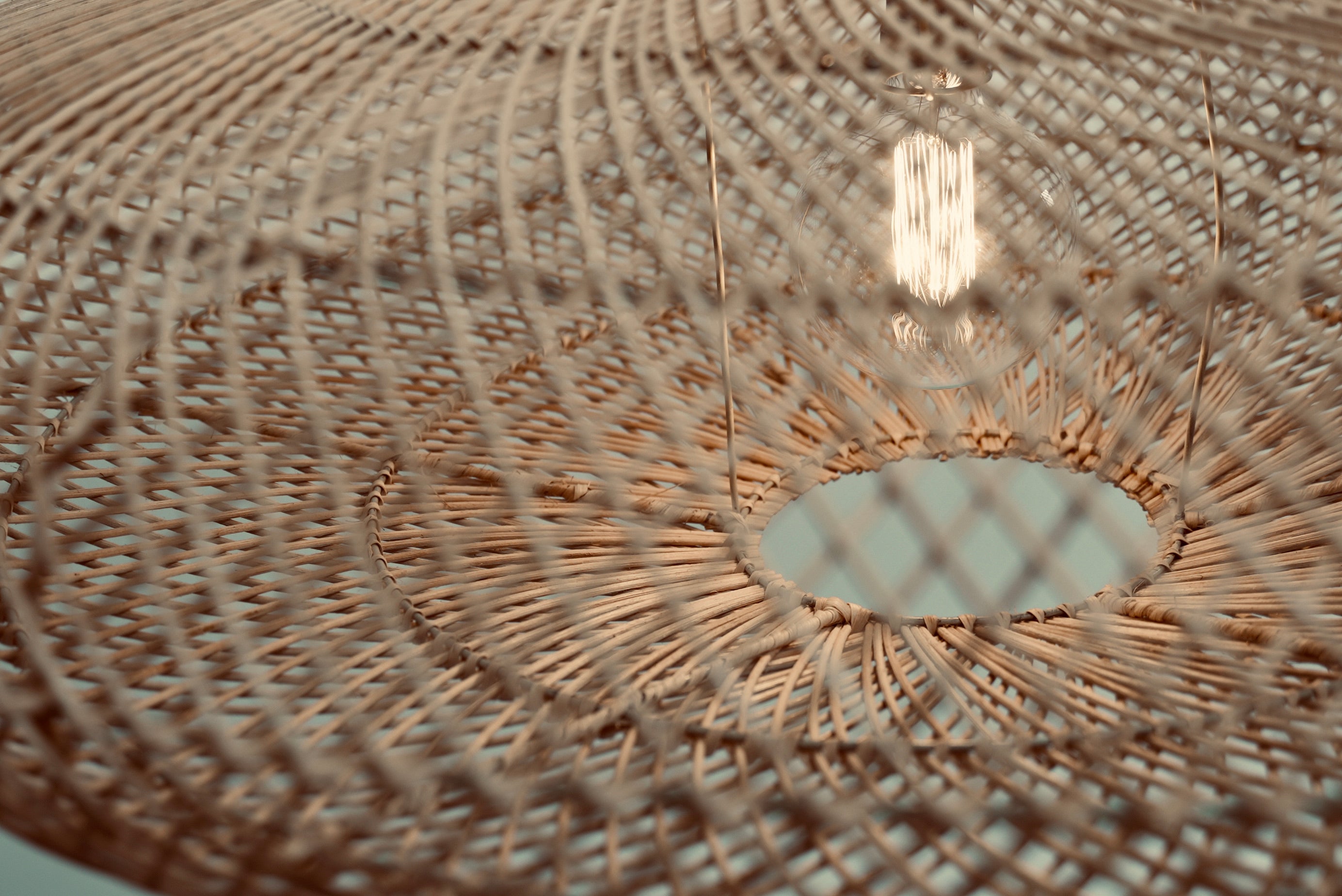 Close-up of the UFO pendant hanging against a neutral background
