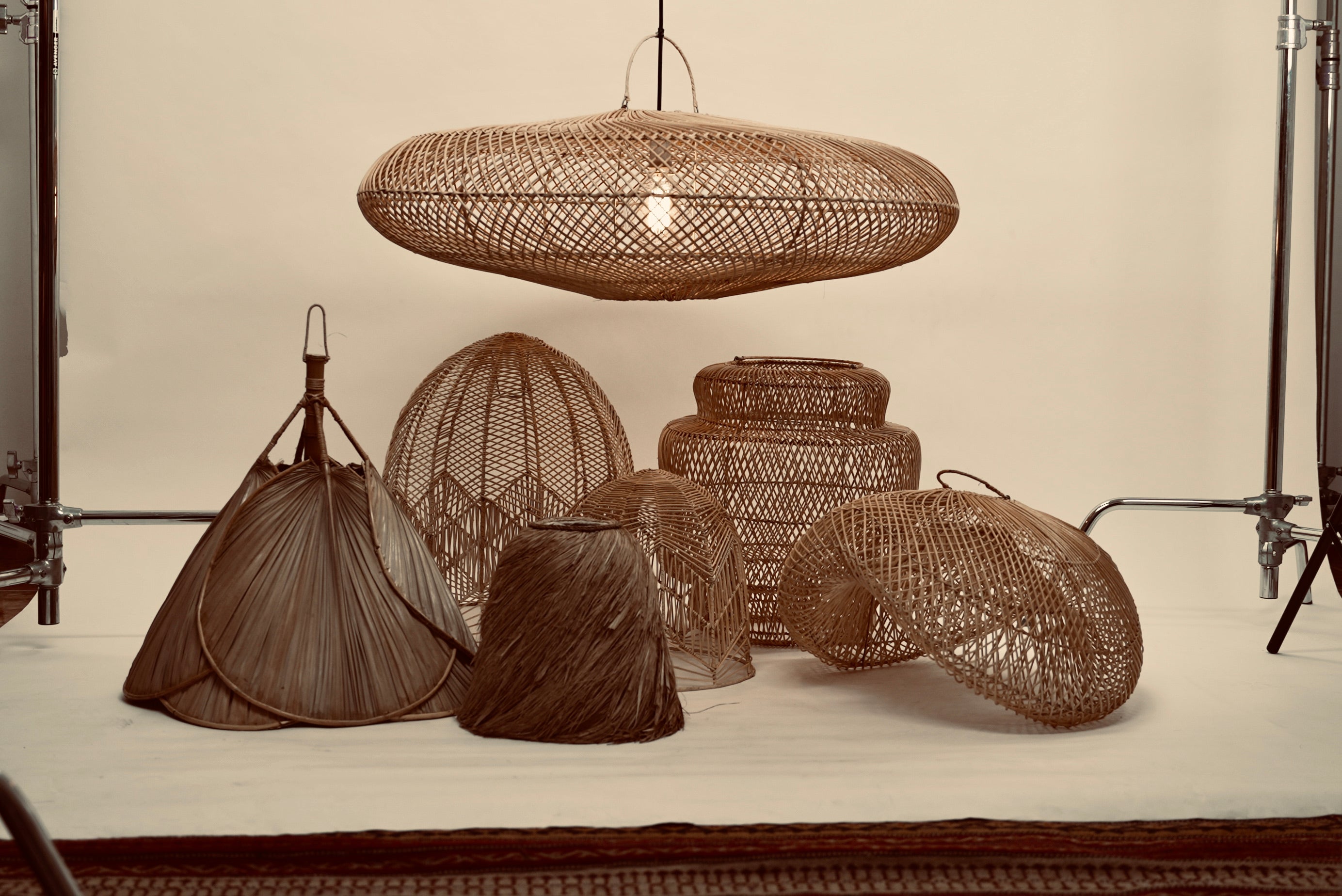 The UFO pendant hanging above a bunch of our other local lampshades against a neutral background