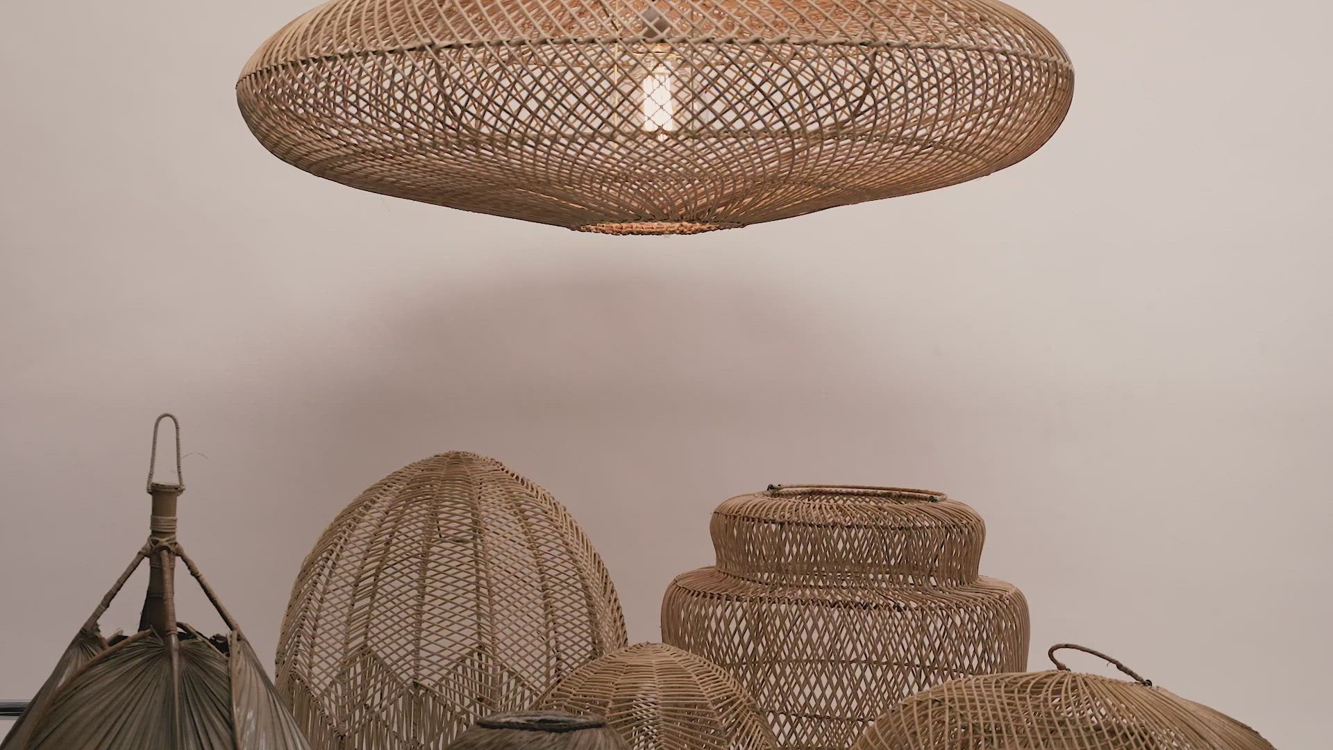 Load video: The UFO pendant hanging above some of our other local lampshades photgraphed against a neutral background