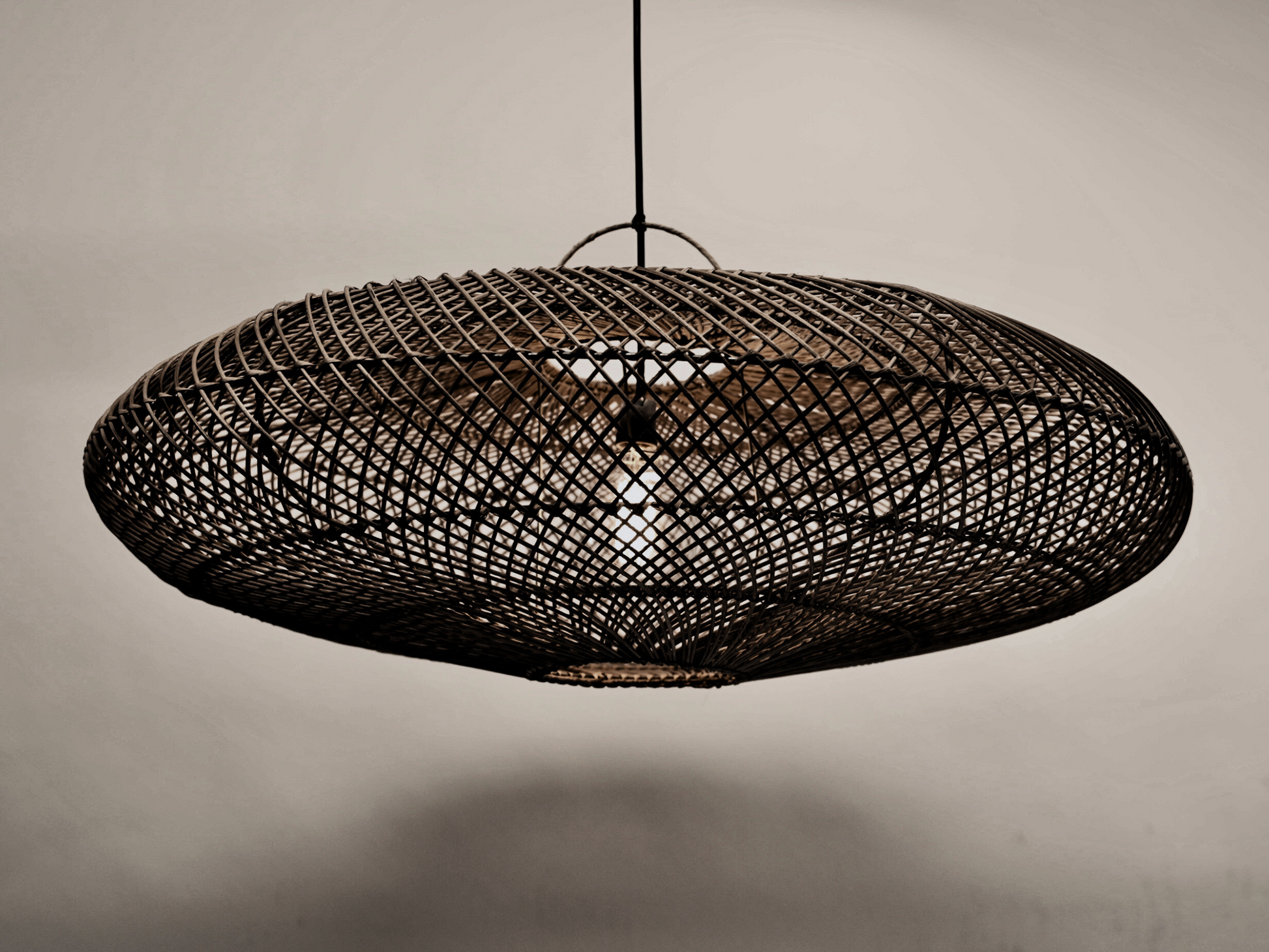 The UFO pendant hanging against a neutral background