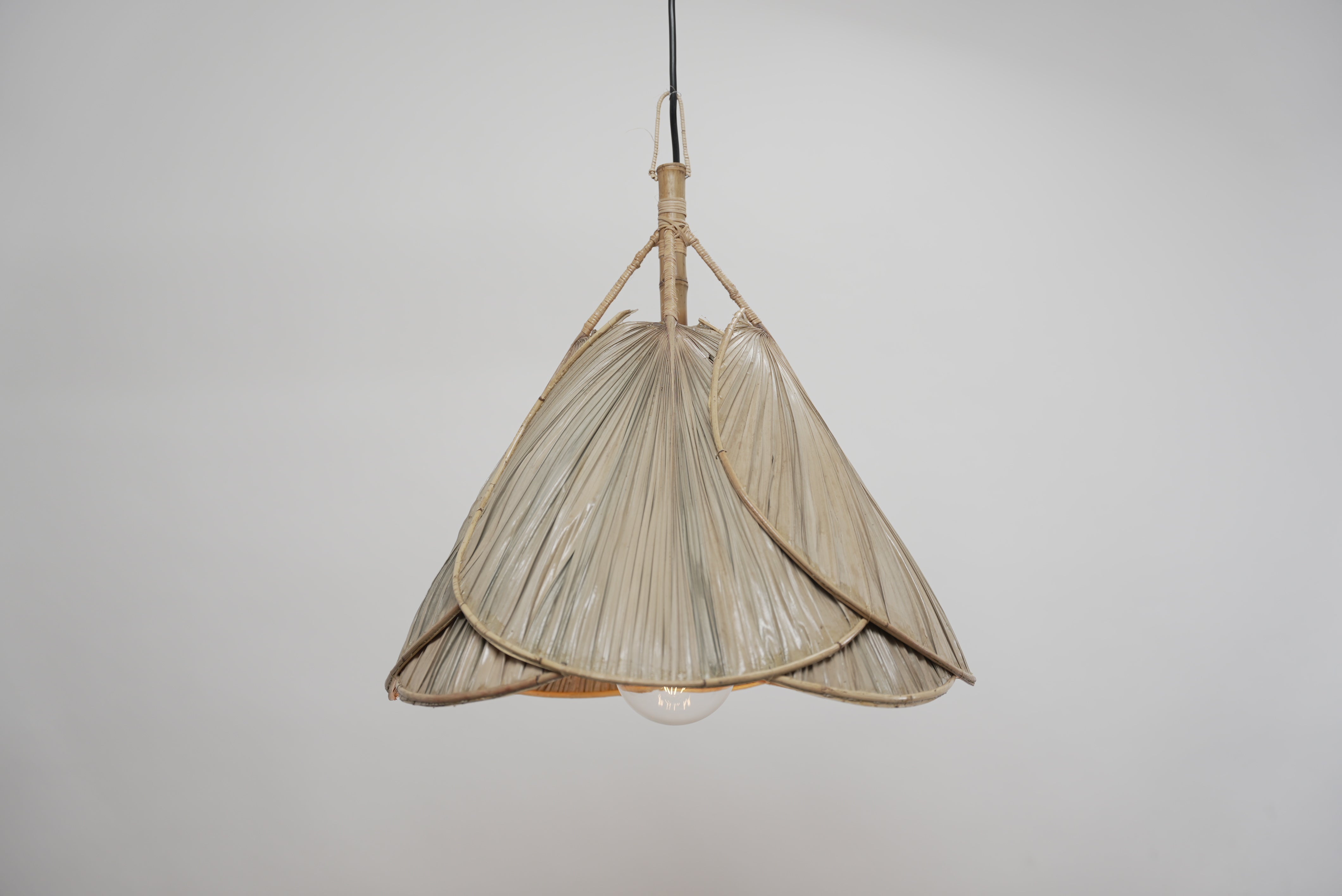 The palm leaf lampshade photographed against a neutral background