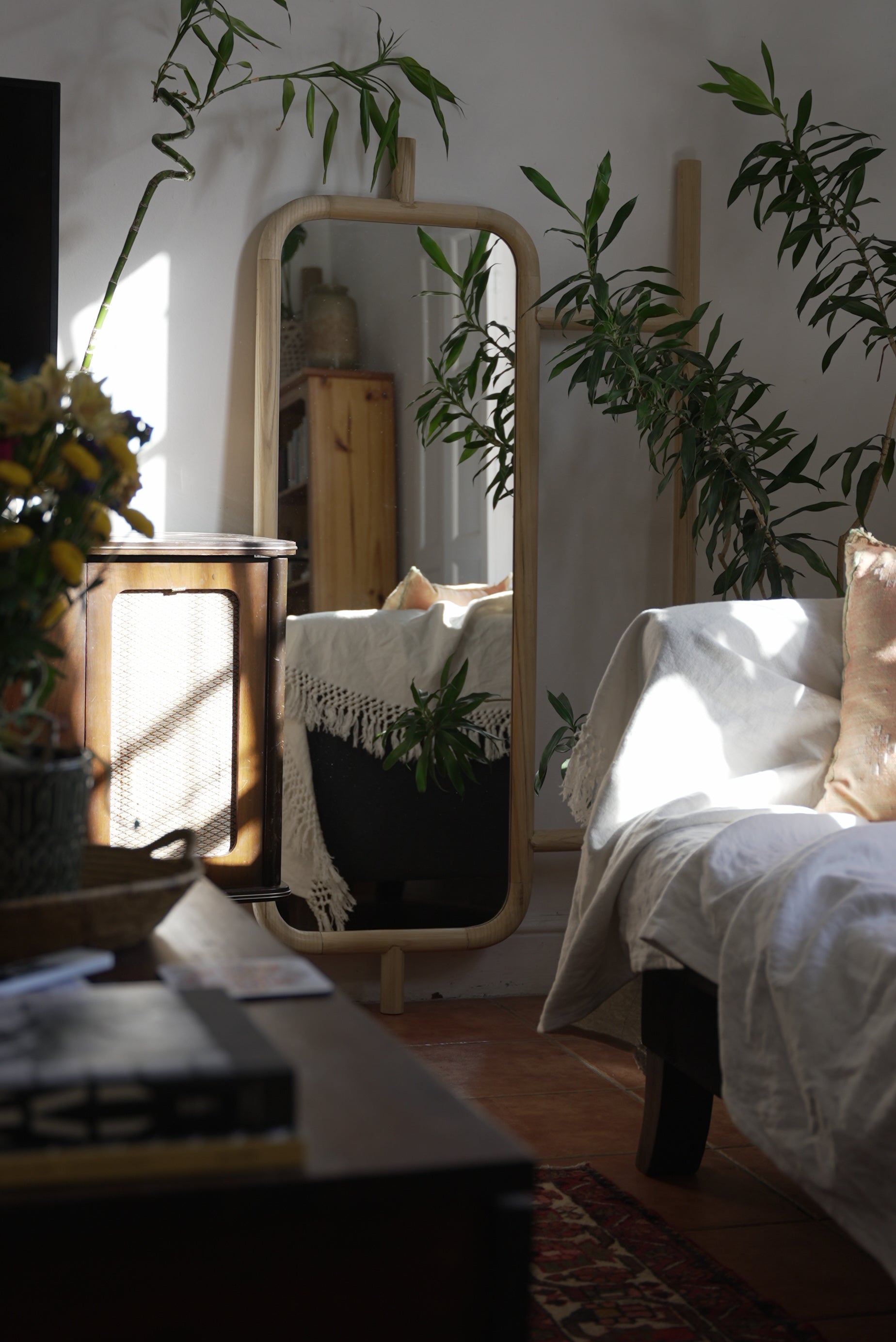 The Muji mirror showcased in a beautiful bedroom with a bohemian theme