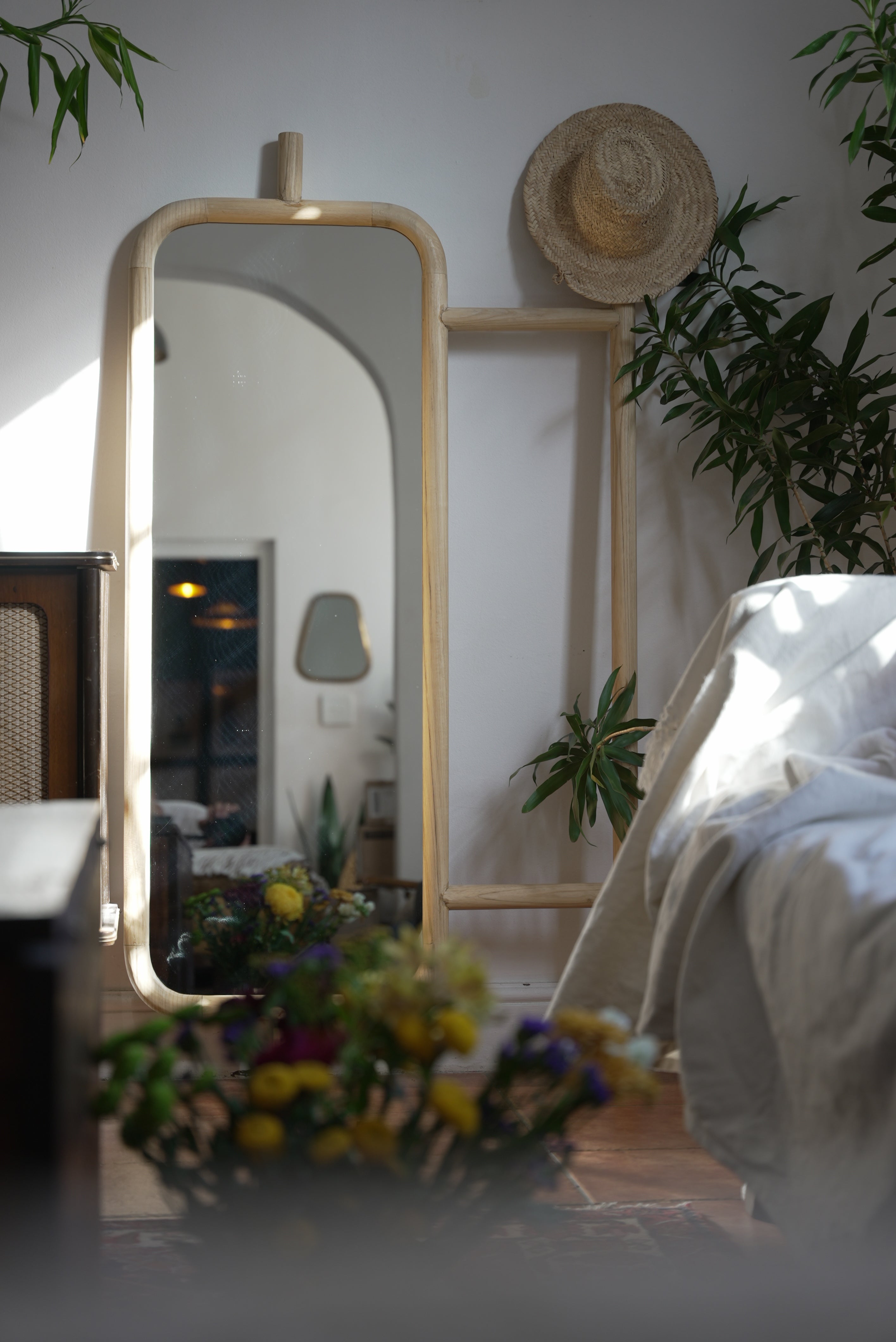 The Muji mirror photographed in a beautiful bedroom with a bohemian theme