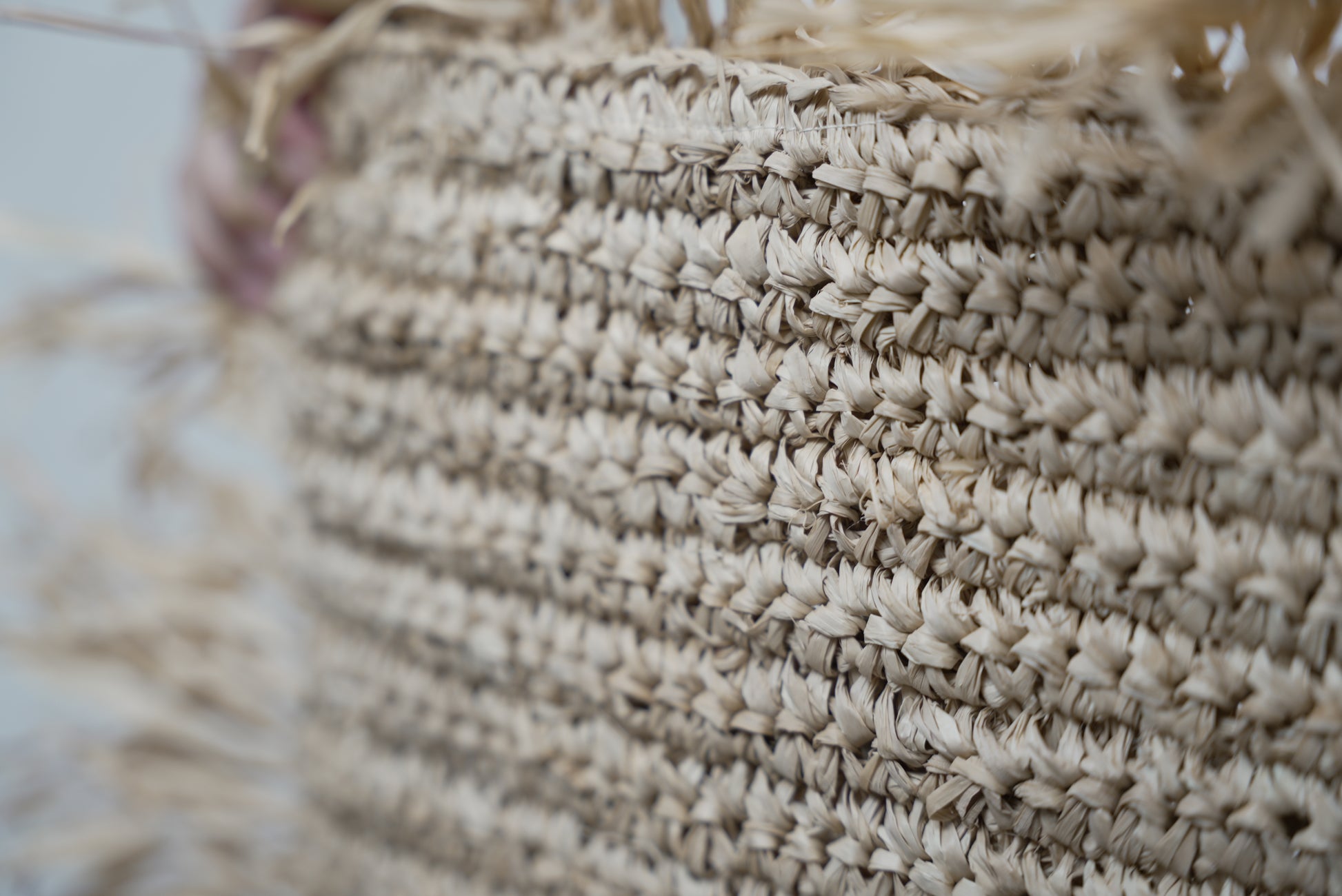 A close-up of the Raffia cushion cover showcasing the intricate weaving