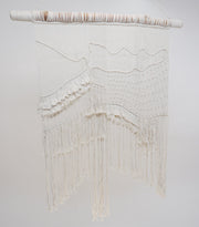 The macrame wall hanger photographed against a neutral background