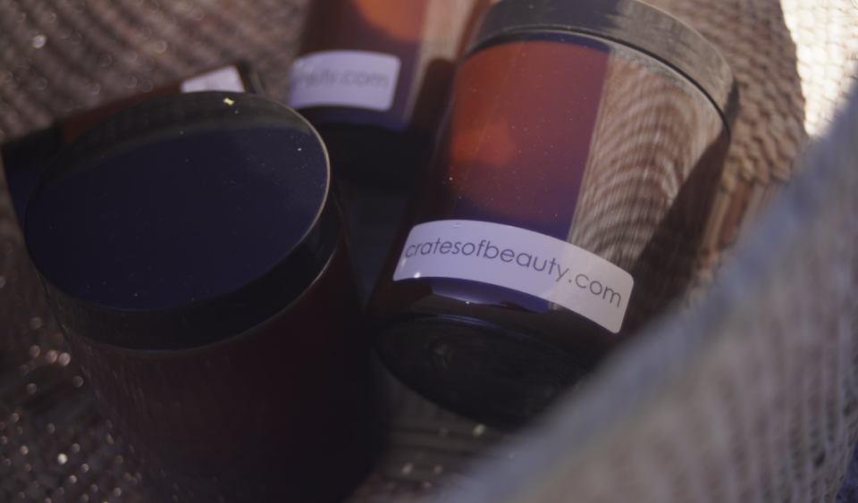 Close-up of soy candles in amber glass jars photographed outside