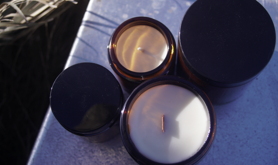 Soy candles in amber glass jars photographed with their different sizes