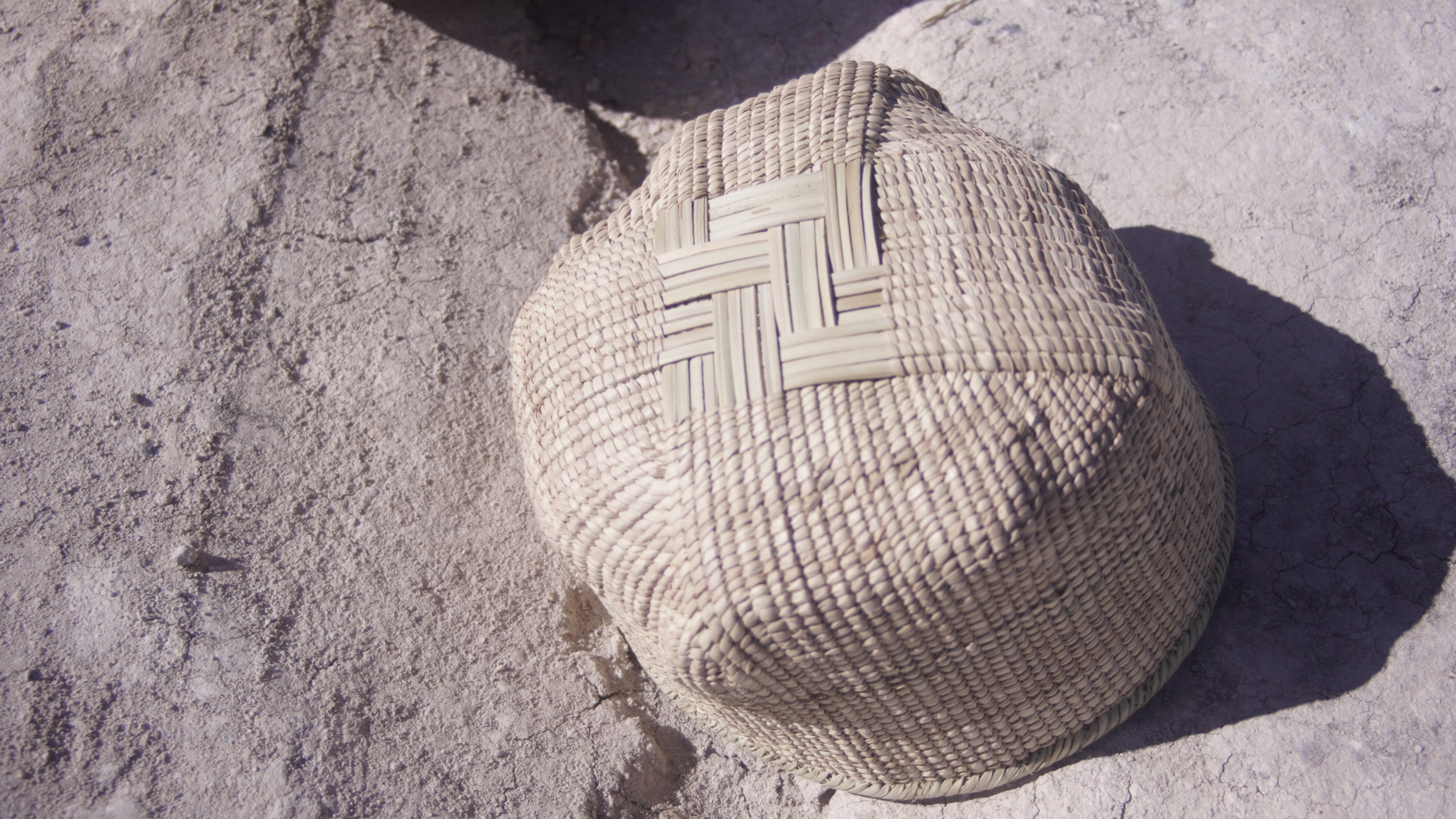 Ilala wonky basket photgraphed from the bottom and shows cross shaped woven pattern