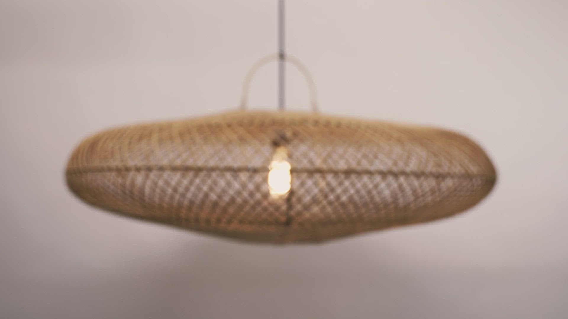 Load video: A close-up of the UFO pendant hanging against a neutral background