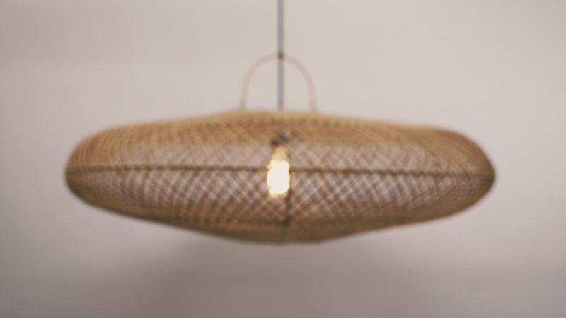 A close-up of the UFO pendant hanging against a neutral background