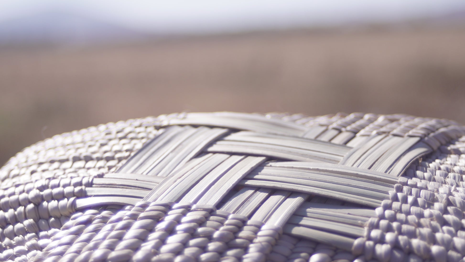 Close-up of the Ilala wonky basket photgraphed from the bottom and shows cross shaped woven pattern