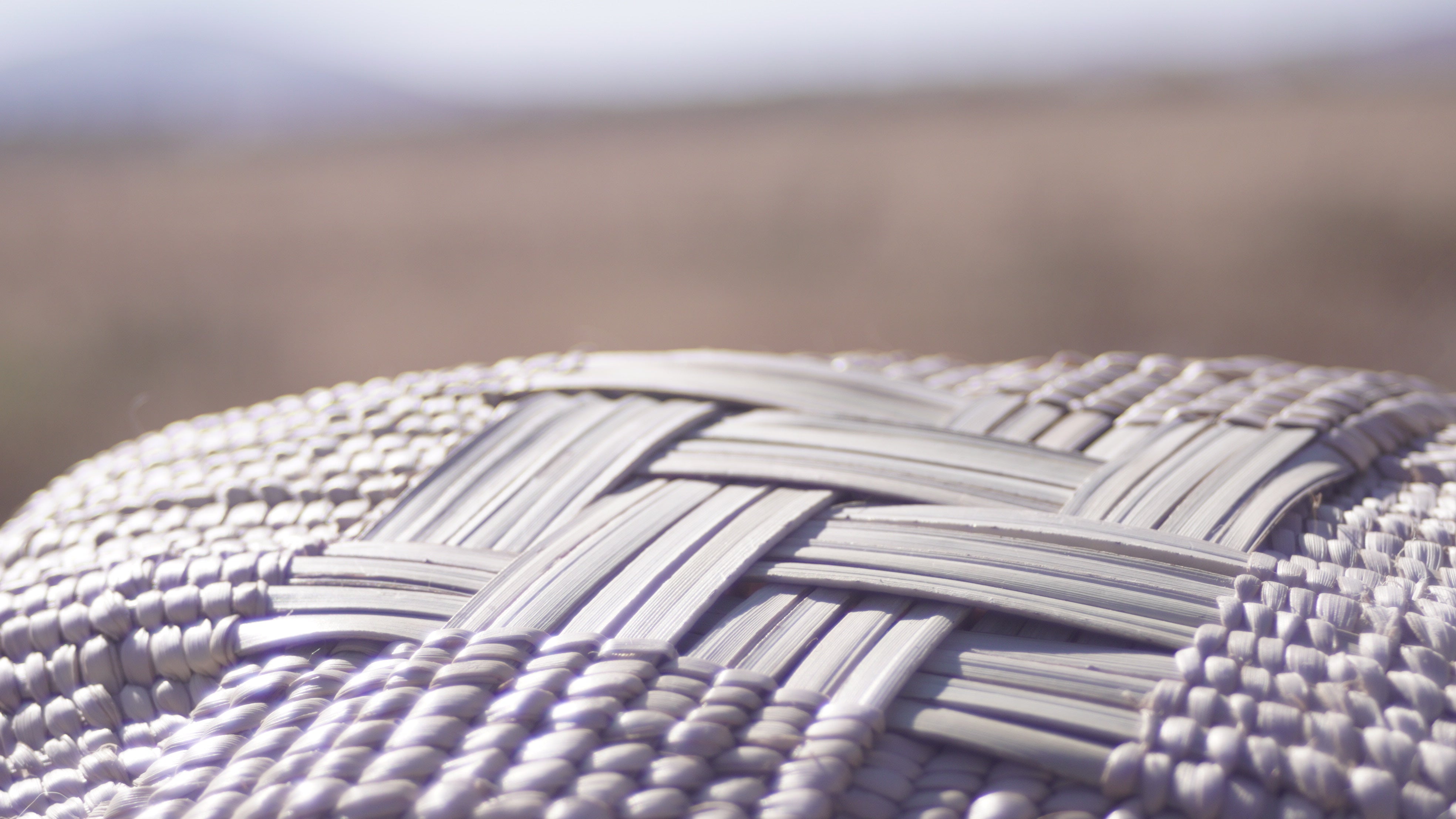Close-up of the Ilala wonky basket photgraphed from the bottom and shows cross shaped woven pattern